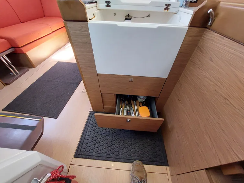 Slide: The Image of Interior of 2013 Jeanneau Sun Odyssey 44 DS with red seating and wooden table. - 54