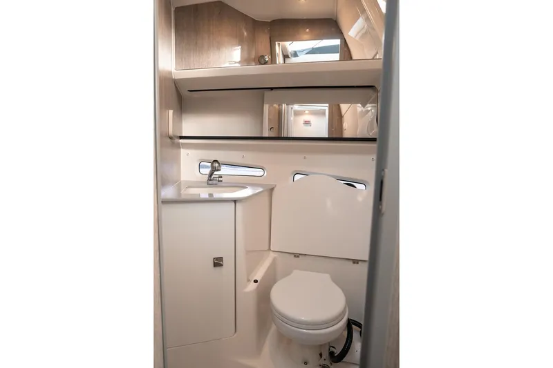 Slide: The Image of 2026 Trophy T29 Explorer boat bathroom with sink, toilet, and mirror. - 12