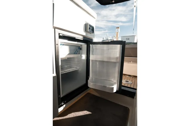 Slide: The Image of Open refrigerator on 2026 Trophy T29 Explorer boat, showcasing interior storage space. - 20