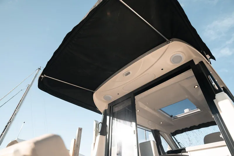 Slide: The Image of 2026 Trophy T29 Explorer boat with canopy under clear sky. - 28