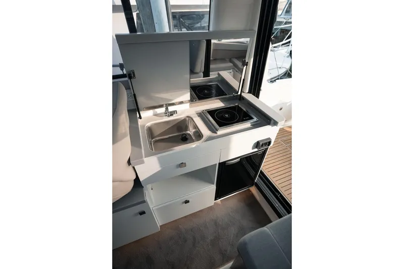 Slide: The Image of Compact kitchen area in 2026 Trophy T29 Explorer boat with sink and stove. - 7