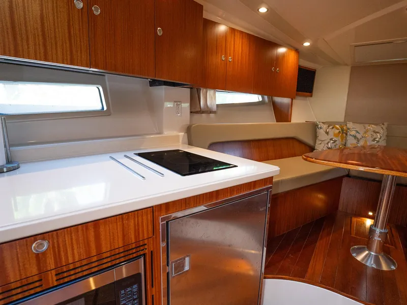 Slide: The Image of Luxurious interior of 2014 Pursuit SC 365i Sport Coupe with modern kitchen and seating area. - 18