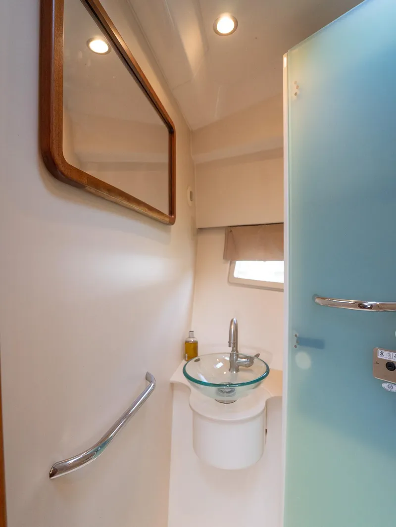 Slide: The Image of 2014 Pursuit SC 365i Sport Coupe bathroom with glass sink and modern fixtures. - 21