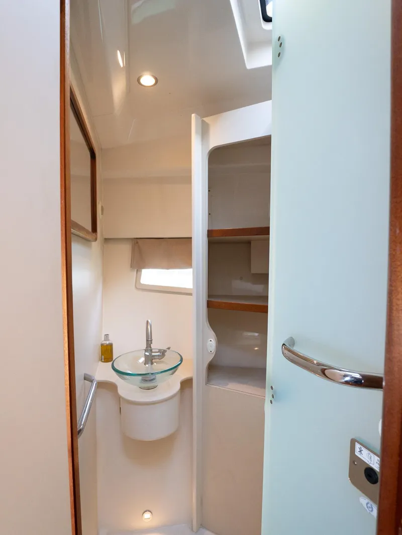 Slide: The Image of 2014 Pursuit SC 365i Sport Coupe bathroom with modern sink and storage shelves. - 22