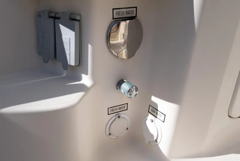 Slide: The Image of 2014 Pursuit SC 365i Sport Coupe water connections: fresh and raw water access points. - 28