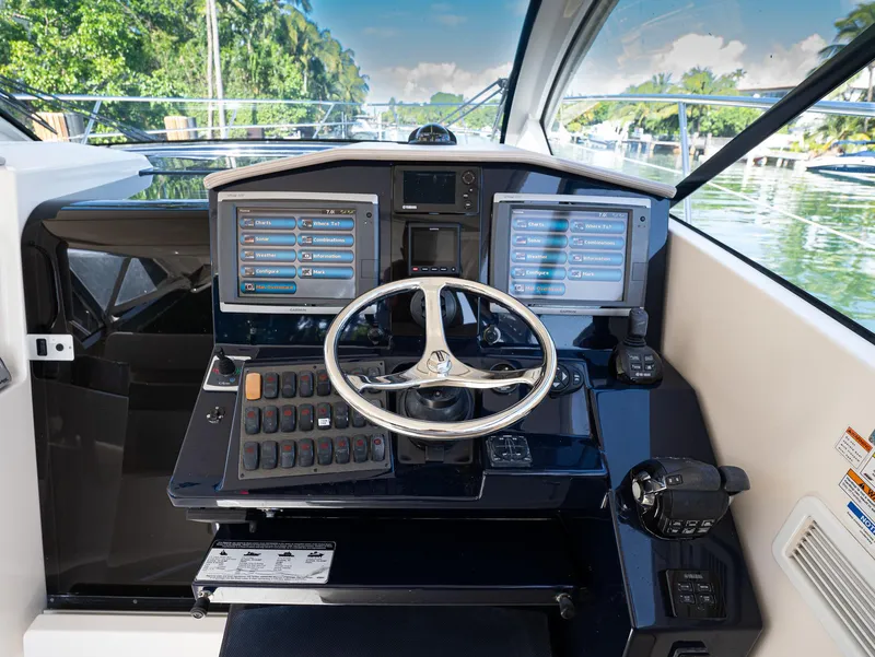 Slide: The Image of Helm of 2014 Pursuit SC 365i Sport Coupe with dual screens and controls. - 7