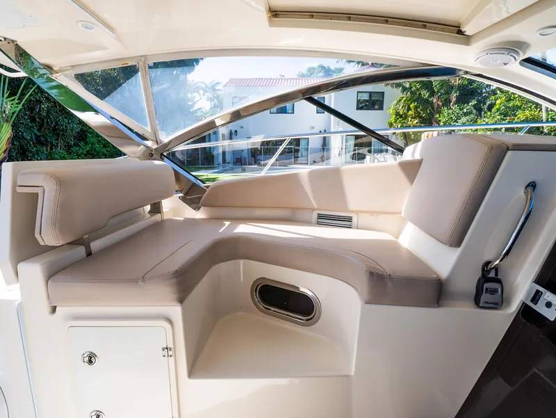 Slide: The Image of Luxurious interior of 2014 Pursuit SC 365i Sport Coupe with beige seating and modern design. - 9