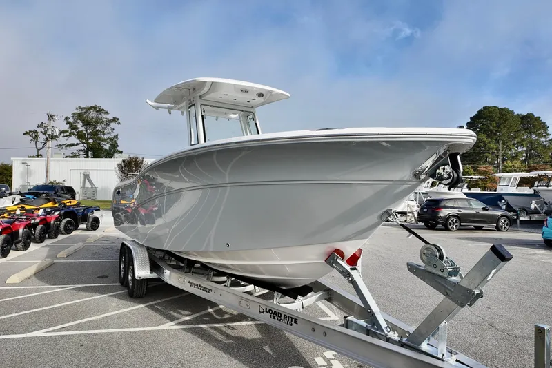 Slide: The Image of 2026 Sea Fox 268 Commander boat on trailer in parking lot, clear sky background. - 6