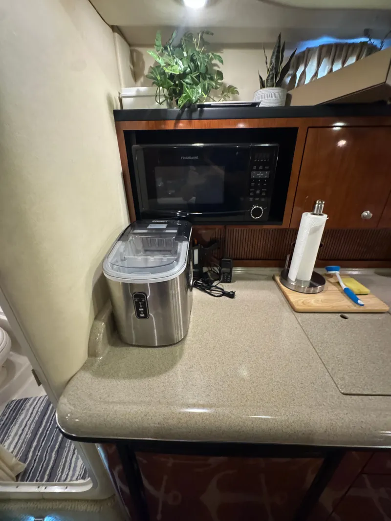 Slide: The Image of 2007 Sea Ray 340 Sundancer kitchen with microwave, ice maker, and countertop accessories. - 15