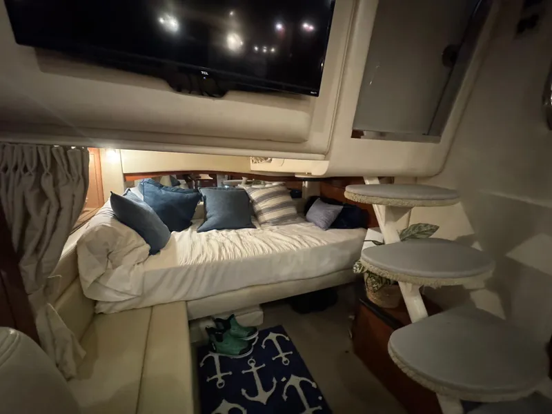 Slide: The Image of Interior of 2007 Sea Ray 340 Sundancer with cozy bed, pillows, and nautical decor. - 18