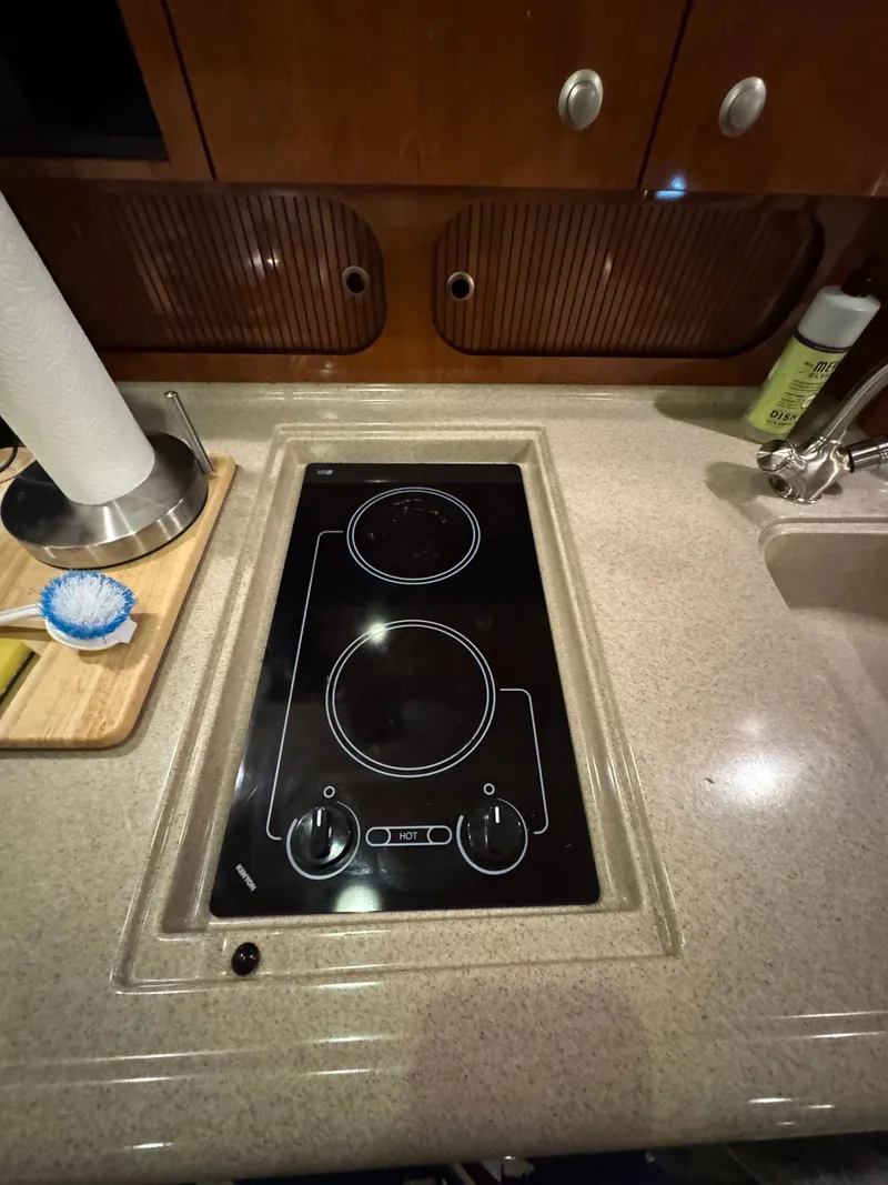 Slide: The Image of Stovetop in 2007 Sea Ray 340 Sundancer yacht kitchen, featuring sleek design and modern amenities. - 19