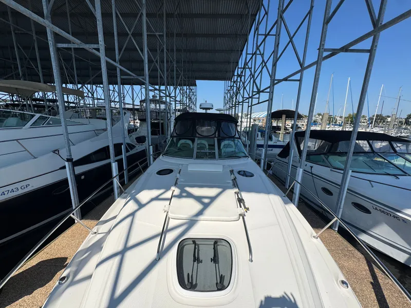 Slide: The Image of 2007 Sea Ray 340 Sundancer docked in a marina under a metal canopy. - 3