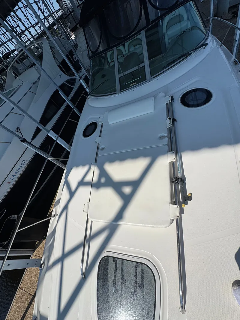 Slide: The Image of 2007 Sea Ray 340 Sundancer boat docked, featuring sleek white deck and modern design. - 4