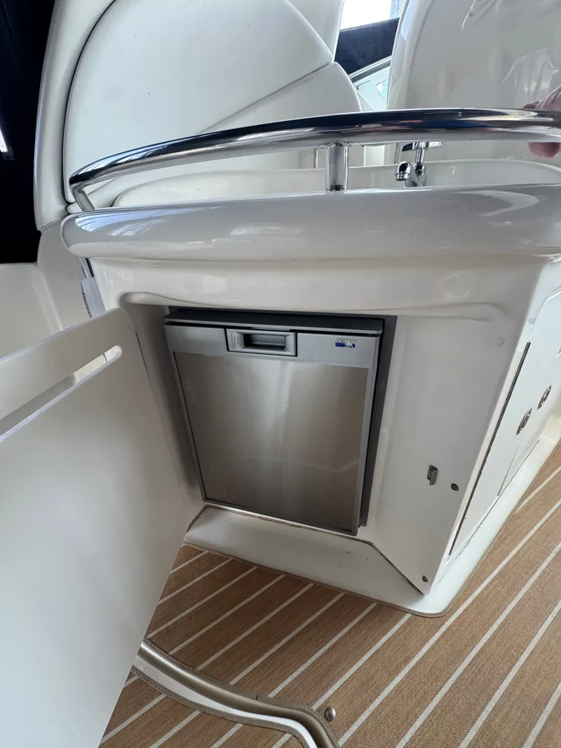 Slide: The Image of 2007 Sea Ray 340 Sundancer interior with built-in stainless steel mini fridge. - 8