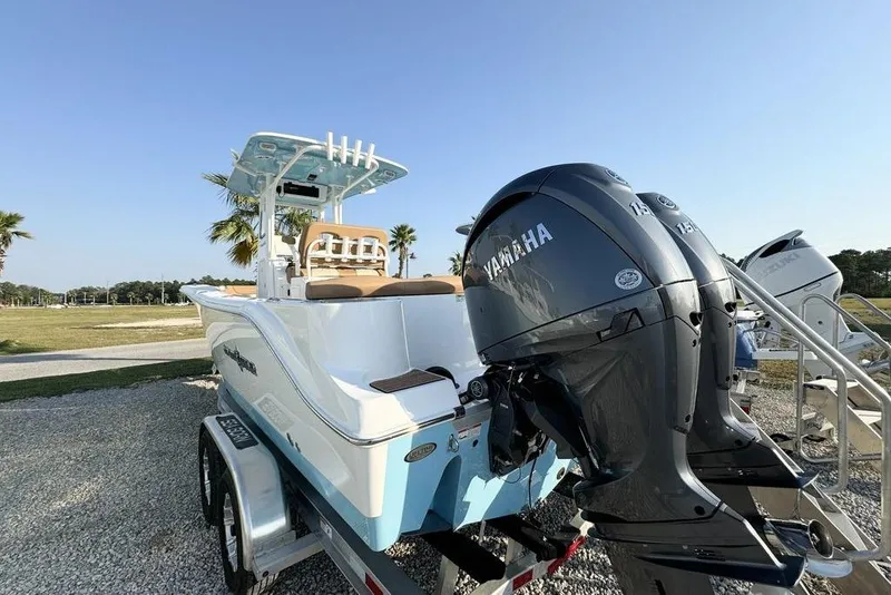 Slide: The Image of 2024 NauticStar 252 Legacy boat with Yamaha engines on a trailer, outdoors. - 11