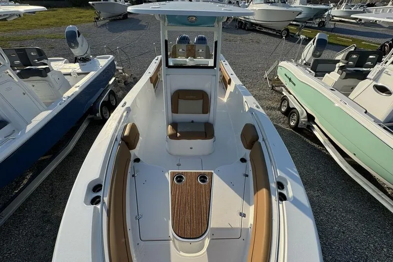 Slide: The Image of 2024 NauticStar 252 Legacy boat with spacious seating and sleek design in a showroom. - 12