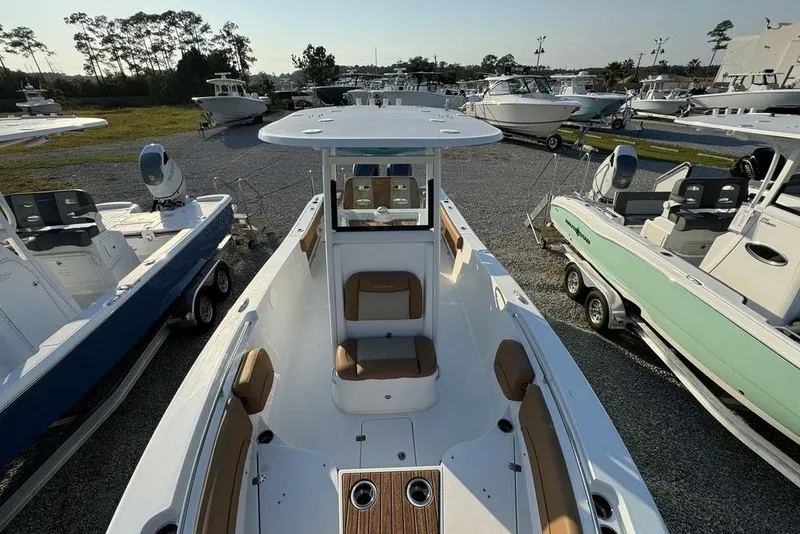 Slide: The Image of 2024 NauticStar 252 Legacy boat displayed in a marina, surrounded by other boats. - 14