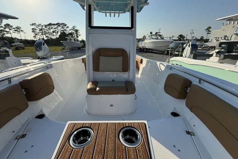 Slide: The Image of 2024 NauticStar 252 Legacy boat interior with cushioned seating and wood accents. - 15
