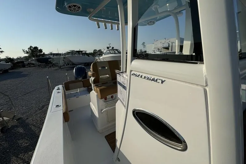 Slide: The Image of 2024 NauticStar 252 Legacy boat, side view, showcasing seating and deck features. - 18