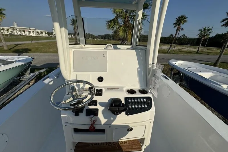 Slide: The Image of 2024 NauticStar 252 Legacy boat console with steering wheel and control panel. - 22