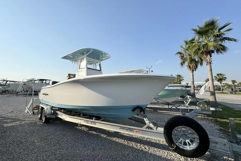Slide: The Image of 2024 NauticStar 252 Legacy boat on trailer, parked outdoors under clear sky. - 6