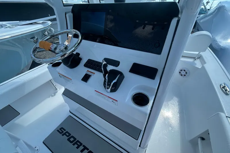 Slide: The Image of 2025 Sportsman Masters 227 Bay Boat console with steering wheel and controls. - 14