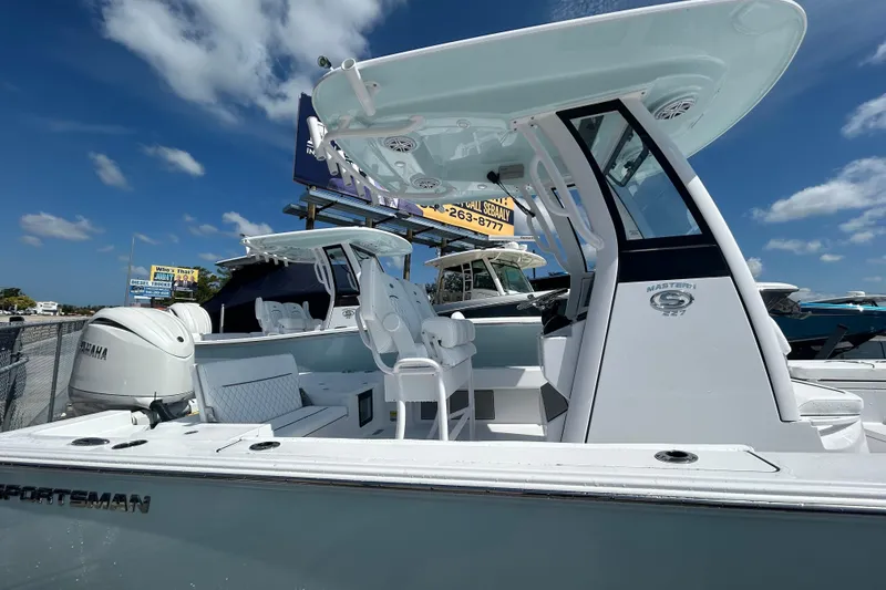 Slide: The Image of 2025 Sportsman Masters 227 Bay Boat with Yamaha engine under clear blue sky. - 17
