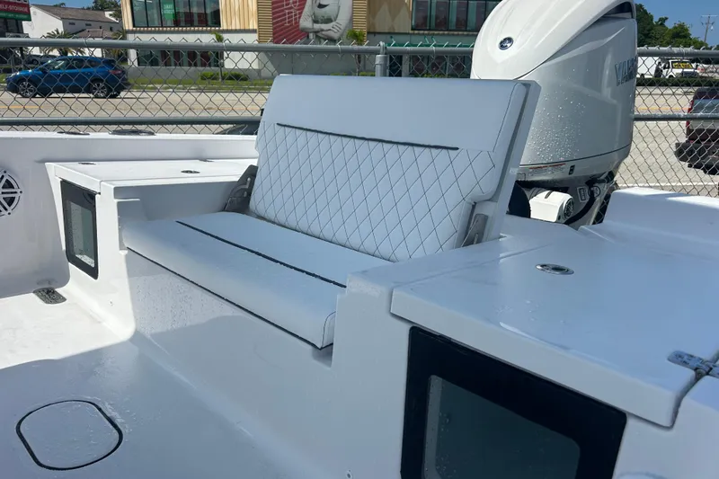 Slide: The Image of 2025 Sportsman Masters 227 Bay Boat interior with white seating and Yamaha engine. - 18