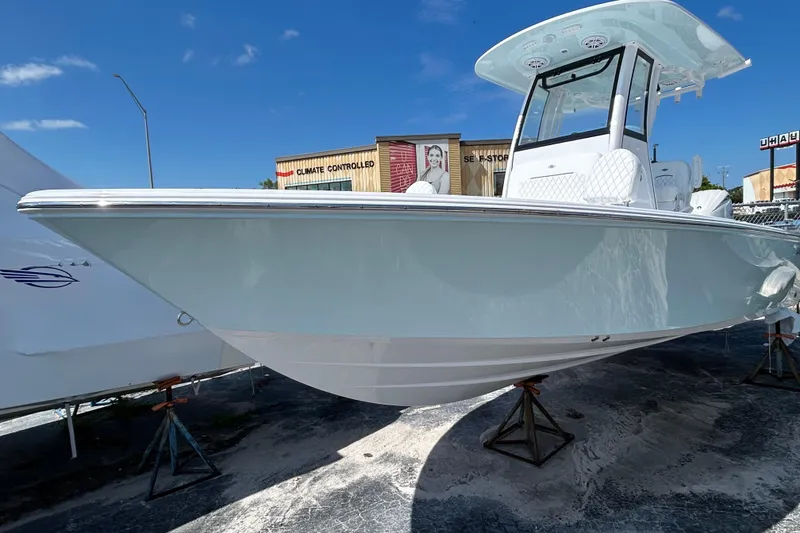 Slide: The Image of 2025 Sportsman Masters 227 Bay Boat on display under clear blue sky. - 2