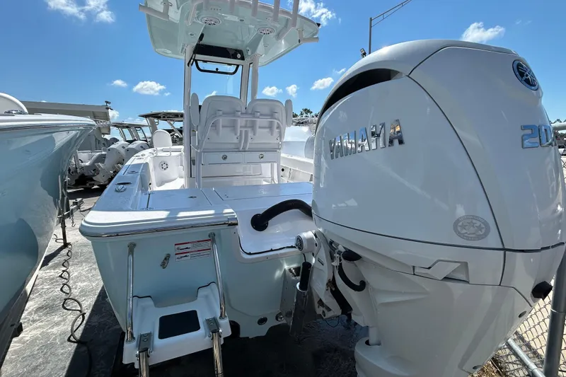 Slide: The Image of 2025 Sportsman Masters 227 Bay Boat with Yamaha engine, docked under clear blue sky. - 8