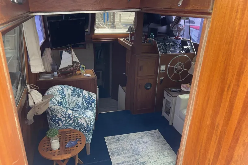 Slide: The Image of Interior of 1985 Marinette DC 39 boat with nautical decor and steering wheel. - 11