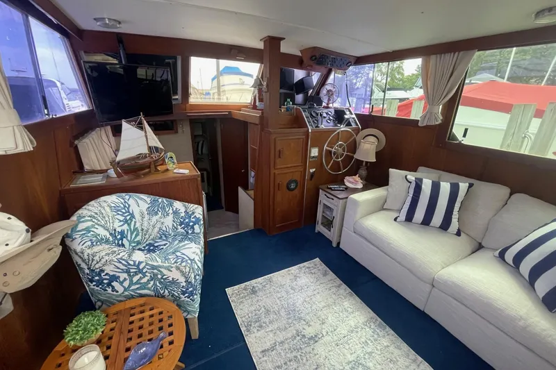 Slide: The Image of Cozy interior of 1985 Marinette DC 39 boat with nautical decor and steering wheel. - 12