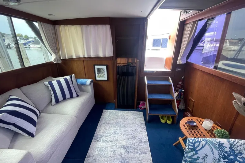 Slide: The Image of Interior of 1985 Marinette DC 39 boat with cozy seating and nautical decor. - 13