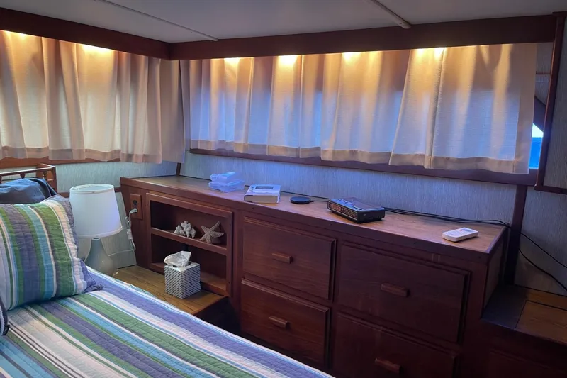 Slide: The Image of Cozy cabin interior of 1985 Marinette DC 39 with striped bedding and wooden furniture. - 15