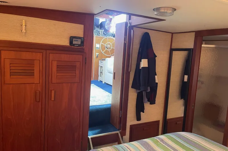 Slide: The Image of Interior of 1985 Marinette DC 39 boat with wooden cabinets and nautical decor. - 17