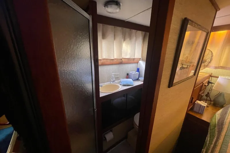 Slide: The Image of Compact bathroom in 1985 Marinette DC 39 boat, featuring sink, shower, and storage. - 19