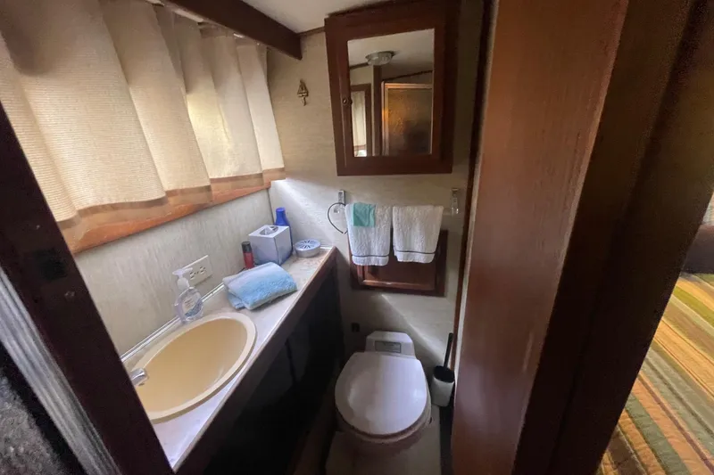 Slide: The Image of Compact bathroom in 1985 Marinette DC 39 boat with sink, toilet, and mirror. - 20