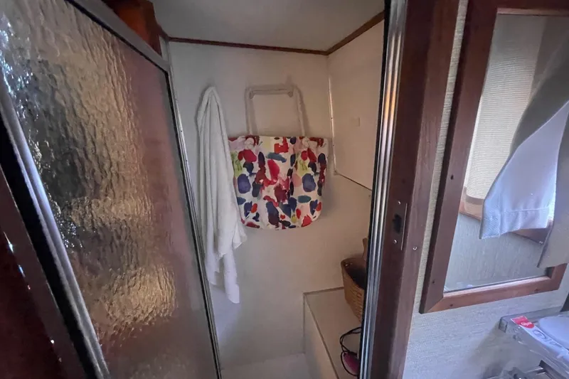 Slide: The Image of Compact bathroom in 1985 Marinette DC 39 boat with shower and colorful bag. - 22