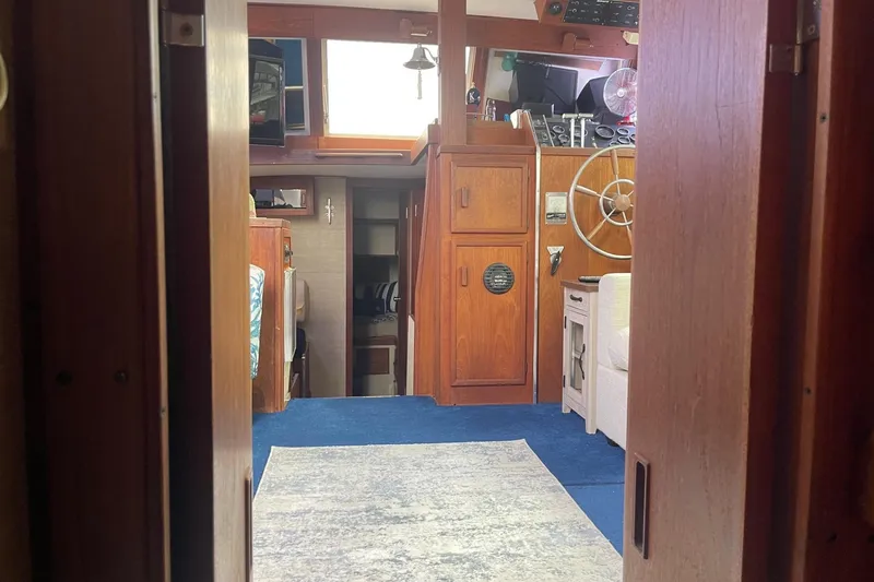 Slide: The Image of Interior of 1985 Marinette DC 39 boat with wooden cabinetry and steering wheel. - 23