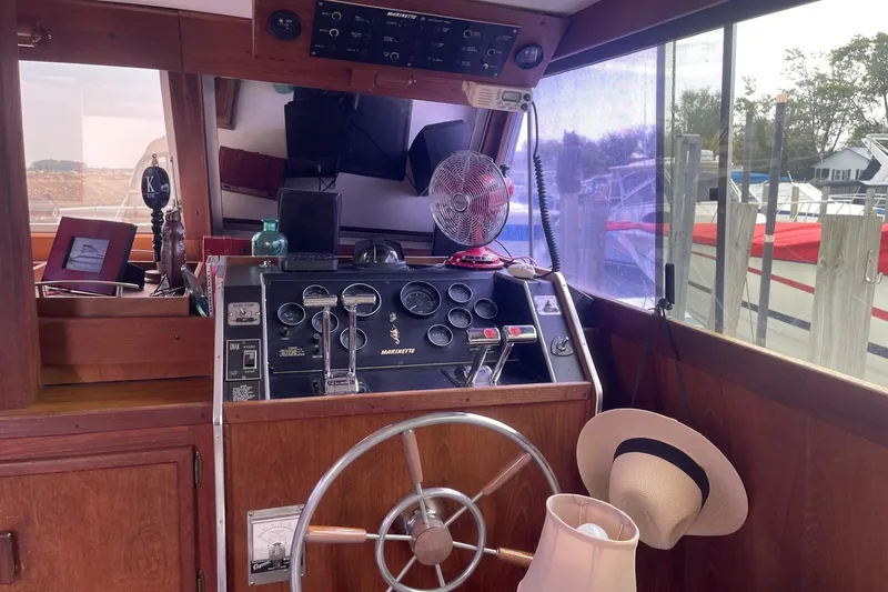 Slide: The Image of Interior of 1985 Marinette DC 39 boat with steering wheel and control panel. - 24