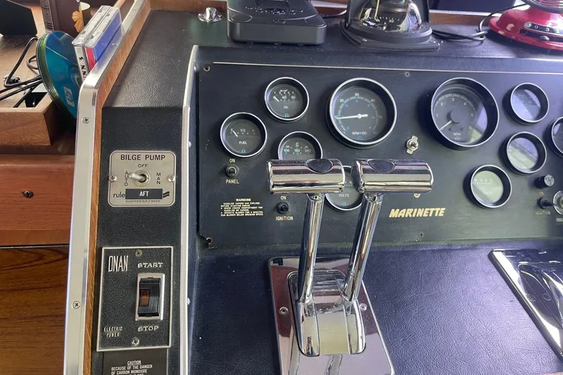 Slide: The Image of Control panel of a 1985 Marinette DC 39 boat with gauges and switches. - 25