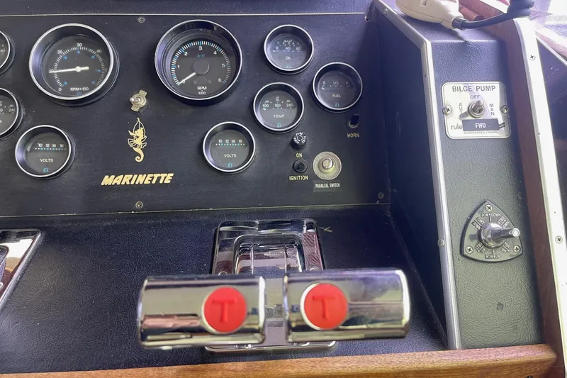 Slide: The Image of Control panel of a 1985 Marinette DC 39 boat with gauges and switches. - 26