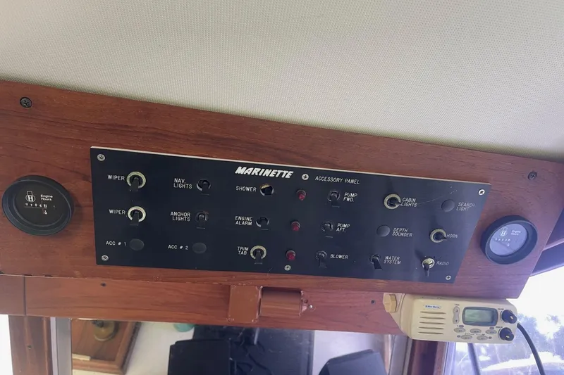 Slide: The Image of Control panel of a 1985 Marinette DC 39 boat with various switches and gauges. - 27