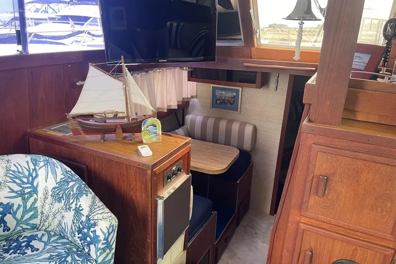 Slide: The Image of Interior of 1985 Marinette DC 39 boat with model ship, TV, and cozy seating area. - 30