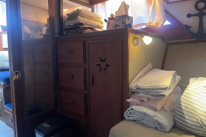 Slide: The Image of Cozy cabin interior of 1985 Marinette DC 39 with wooden cabinets and folded linens. - 32