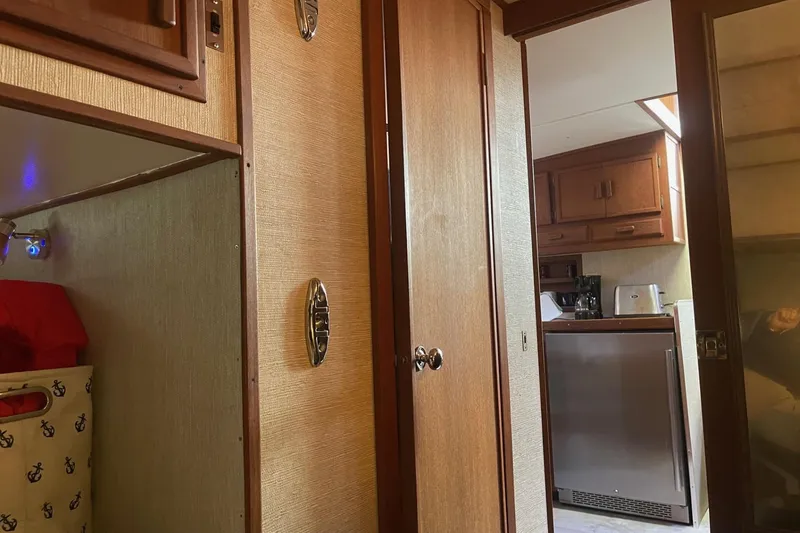 Slide: The Image of Interior of 1985 Marinette DC 39 boat, featuring kitchen and cabin area. - 33