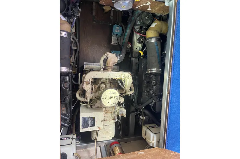 Slide: The Image of Engine compartment of a 1985 Marinette DC 39 boat, showcasing mechanical components and wiring. - 36