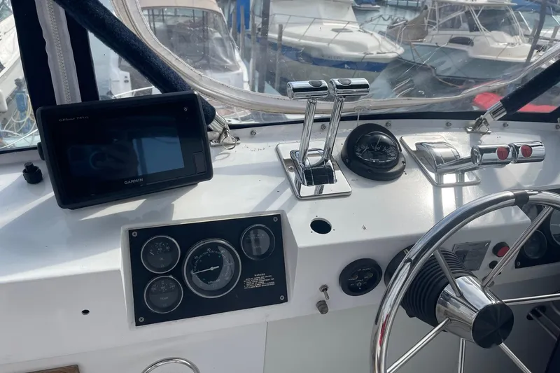 Slide: The Image of Control panel of a 1985 Marinette DC 39 boat with steering wheel and navigation instruments. - 8