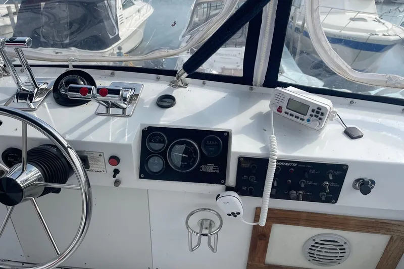 Slide: The Image of Helm of 1985 Marinette DC 39 boat with steering wheel, controls, and gauges. - 9