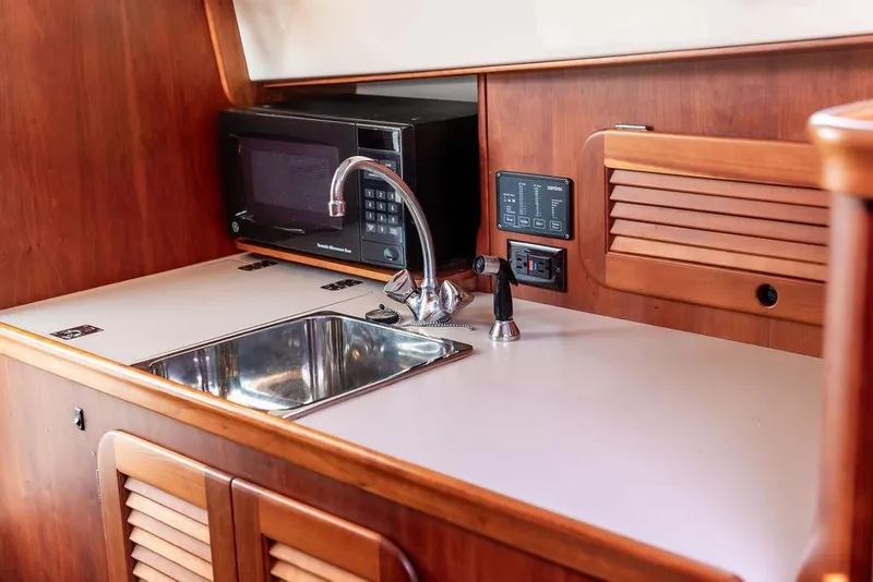 Slide: The Image of Hinckley Picnic Boat EP 2004 interior with sink, microwave, and control panel. - 18